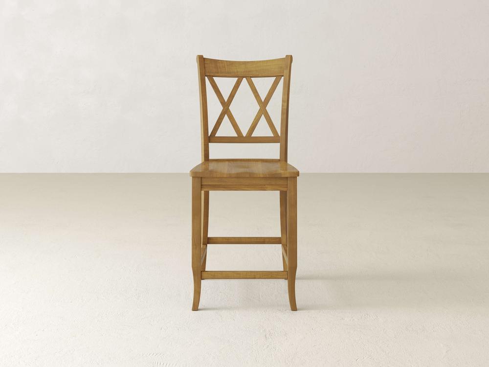 The elegant Double X Back Stool by James & James features a tall crisscross-patterned backrest. It stands on a light floor against an off-white backdrop, showcasing superior craftsmanship.