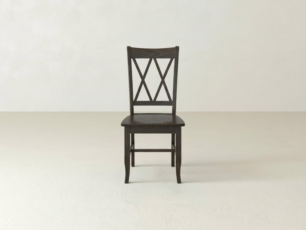 The James+James Double X-Back Dining Chair in dark wood features a classic slatted back, elegantly displayed on a light floor with a plain, light wall backdrop.