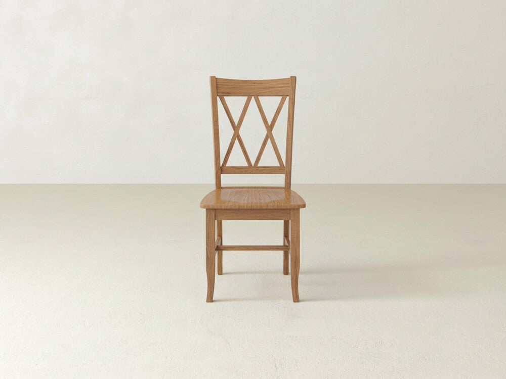 The James+James Double X-Back Dining Chair features a flat wooden seat and distinctive intersecting X-back design, adding timeless elegance to any space with its classic style.