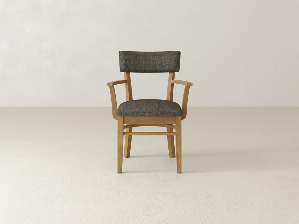 A wooden chair with a dark gray cushioned seat and backrest is positioned against a light gray background. The chair has a simple, elegant design with armrests and clean lines.