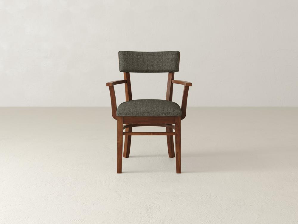 Wooden chair with armrests and a dark green upholstered seat and backrest, set against a plain white background. The chairs design is simple and elegant, featuring a natural wood finish.