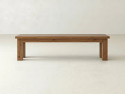 The James+James Farmhouse Bench - Almond on Oak features a rectangular wooden seat and four straight legs, displayed against a plain white background.