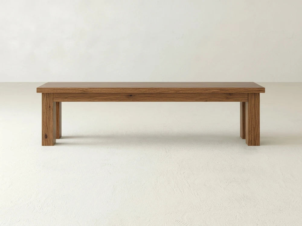 The James+James Farmhouse Bench - Almond on Oak features a rectangular wooden seat and four straight legs, displayed against a plain white background.