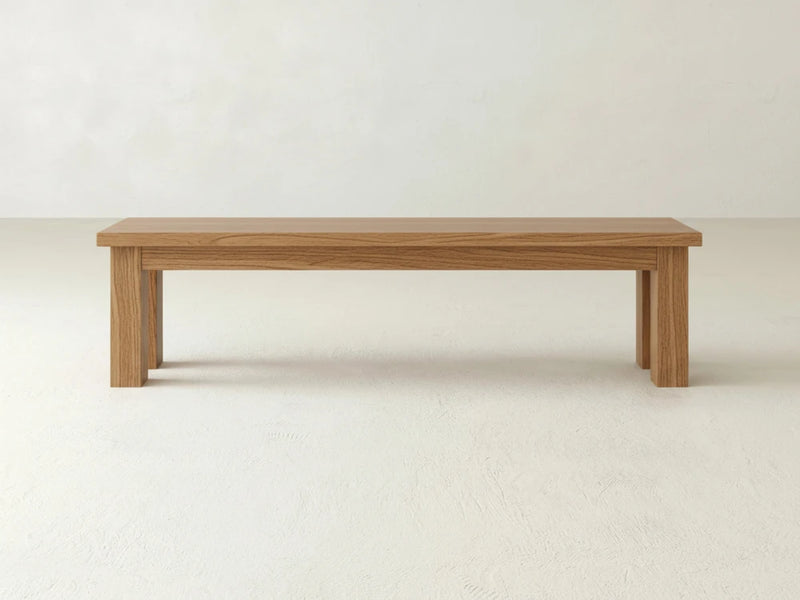 The James+James Farmhouse Bench - Oat on Oak features clean lines and a natural finish, placed on a light floor against a plain white wall.