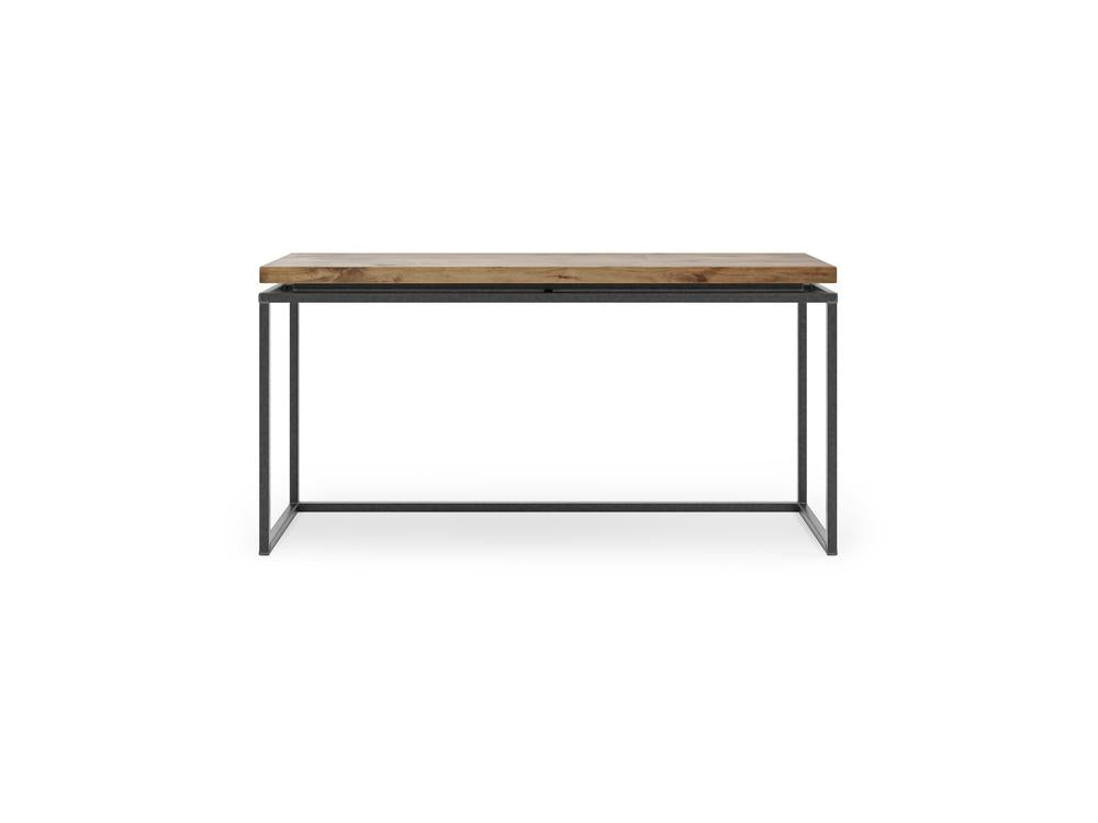 The Floating Top Sofa Table - Harvest Wheat by James+James features a minimalist design with a rustic wooden top and sleek black metal legs. The wooden surface boasts a natural finish, while the legs form a rectangular base, imparting a modern, industrial aesthetic. The table is showcased against a white backdrop.