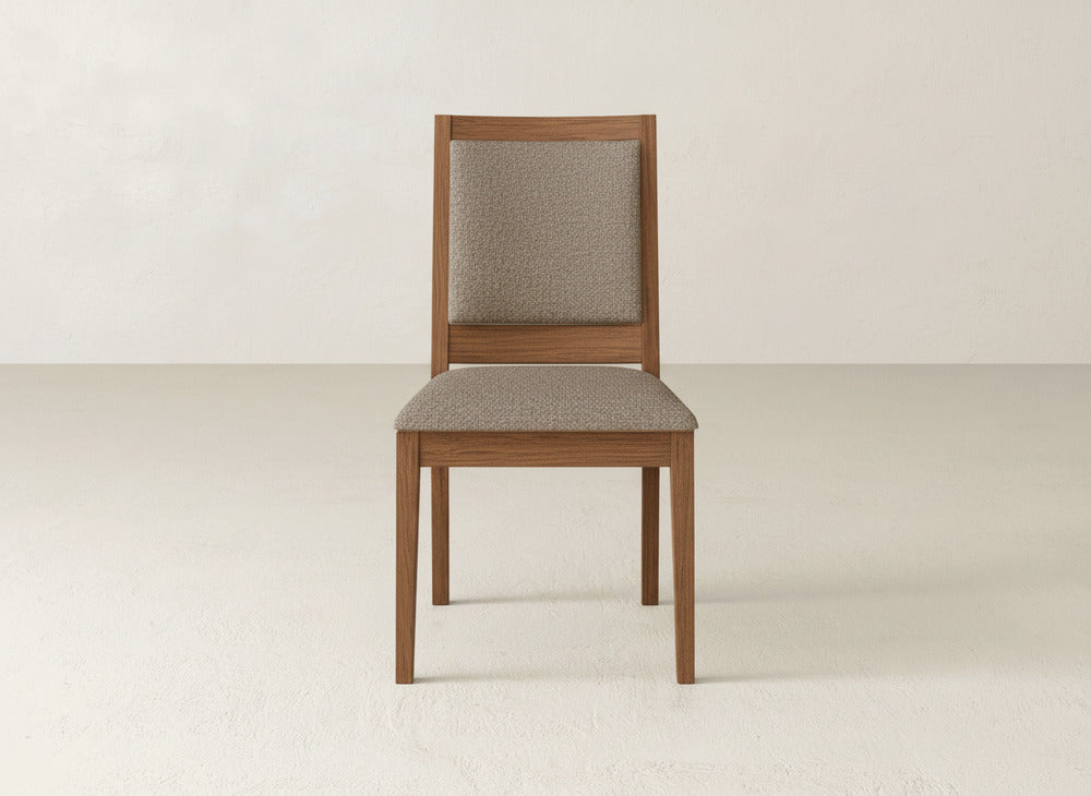 The Gina Side Dining Chair by James+James features a modern light brown maple wood frame with cushioned beige fabric seat and backrest, shown on a light floor against a neutral wall.