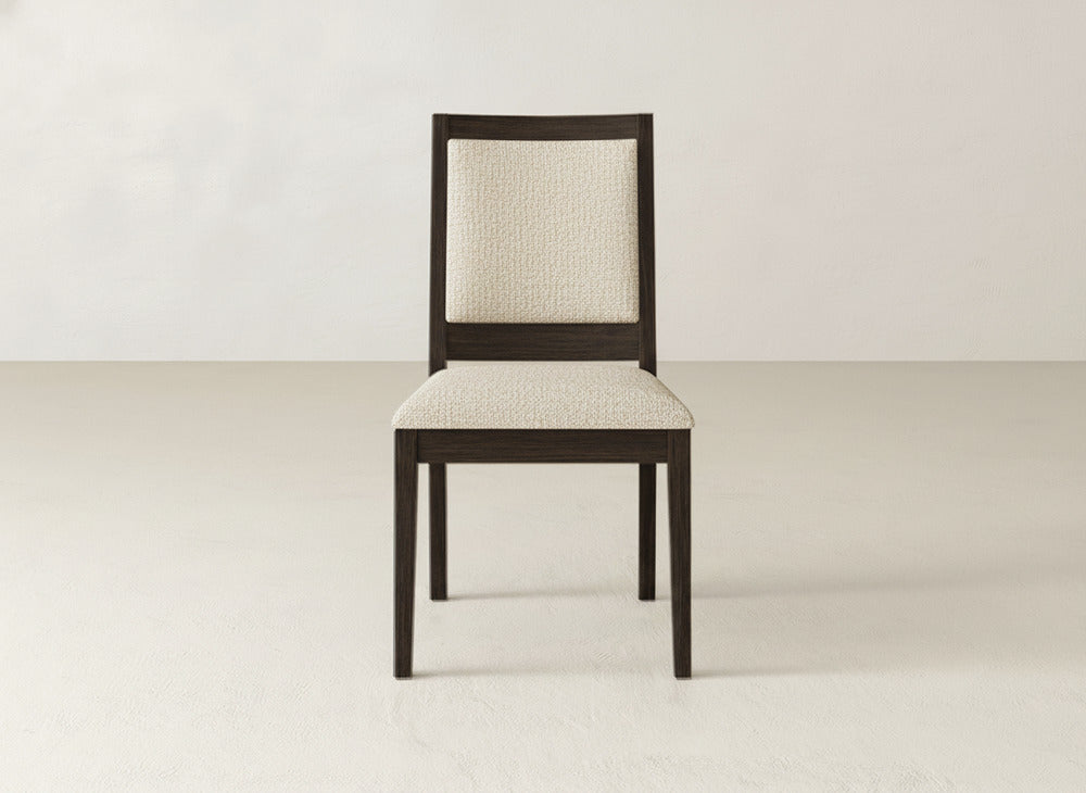 The Gina Side Dining Chair by James+James features a dark brown maple wood frame with a light beige upholstered seat and backrest, shown against a plain light-colored background.