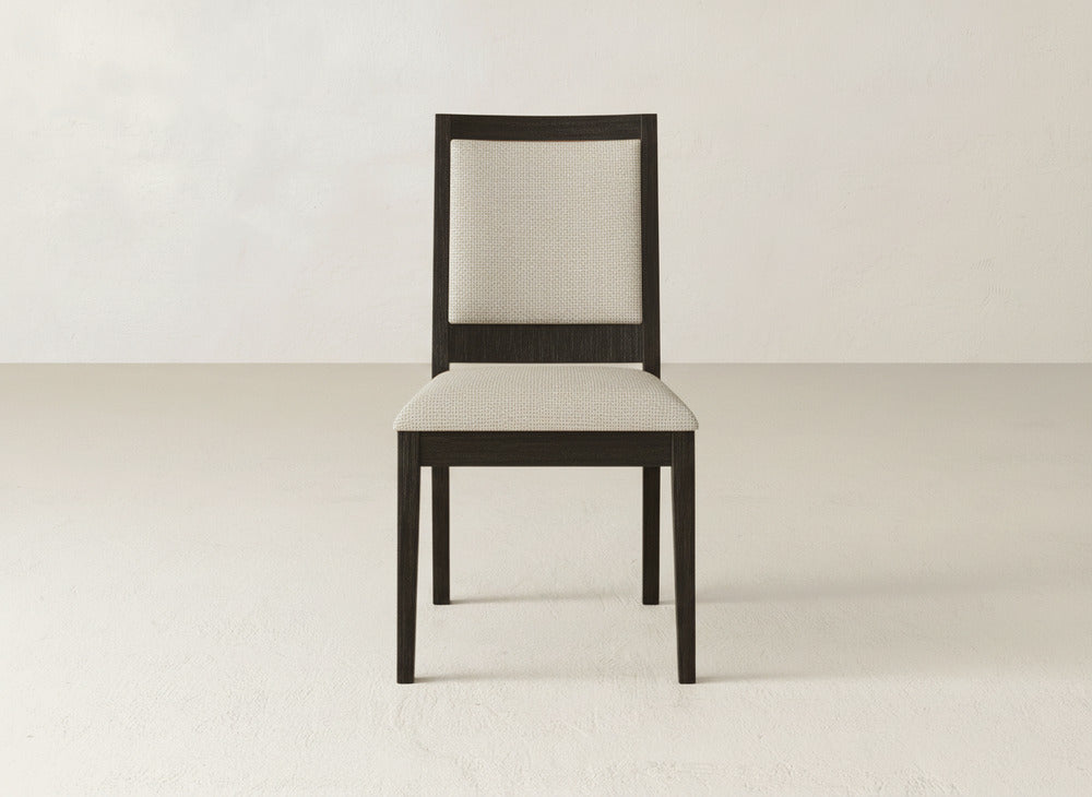The Gina Side Dining Chair by James+James, crafted from dark maple wood, features a light upholstered seat and backrest, centered against a plain light background.