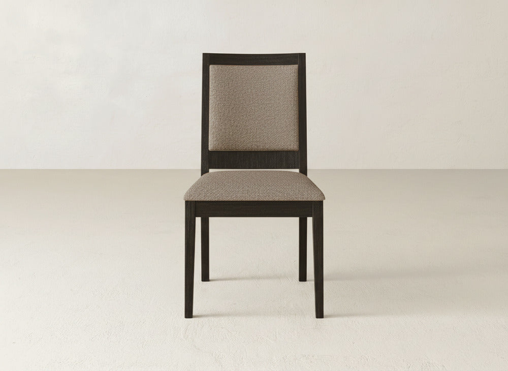 The Gina Side Dining Chair by James+James features a dark maple frame and light beige upholstered seat and backrest, shown on a plain light floor with an off-white wall background.