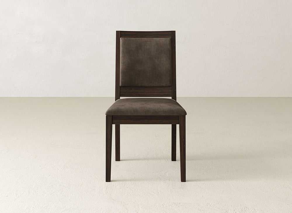 The Gina Side Dining Chair by James+James, made from maple with a dark brown cushioned seat and backrest, is shown facing forward against a plain, light-toned wall and floor.