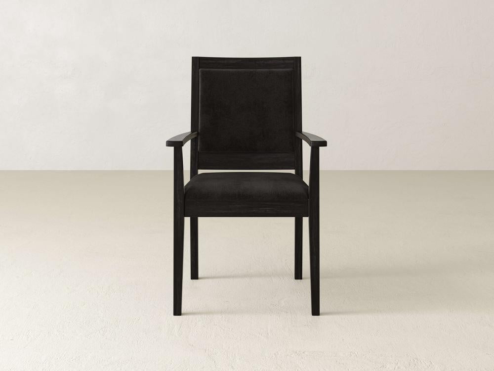 Black upholstered armchair with wooden frame on a beige background. The chair has a square backrest and straight armrests, offering a modern and minimalistic design.