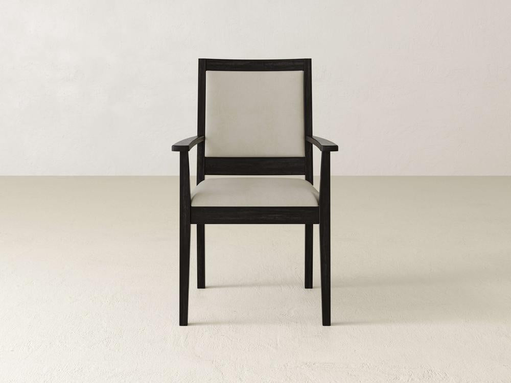 A wooden chair with dark brown frame and light beige cushioned seat and backrest is centered against a plain off-white background. The chair features armrests and a simple, modern design.