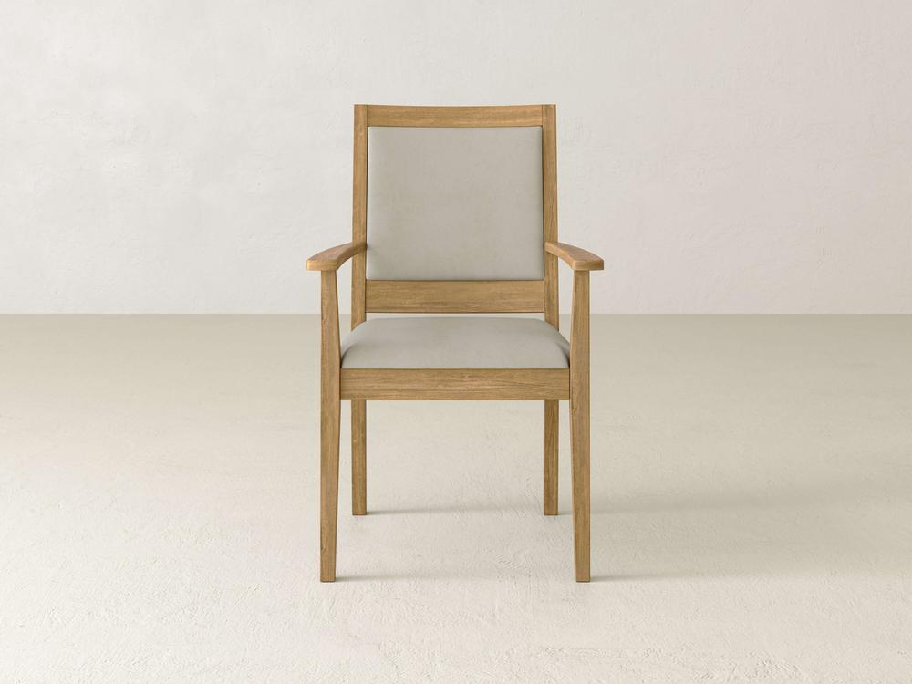 A wooden chair with light gray cushioning on the seat and backrest, positioned against a plain white background. The design is simple and modern, featuring armrests and a straight back.