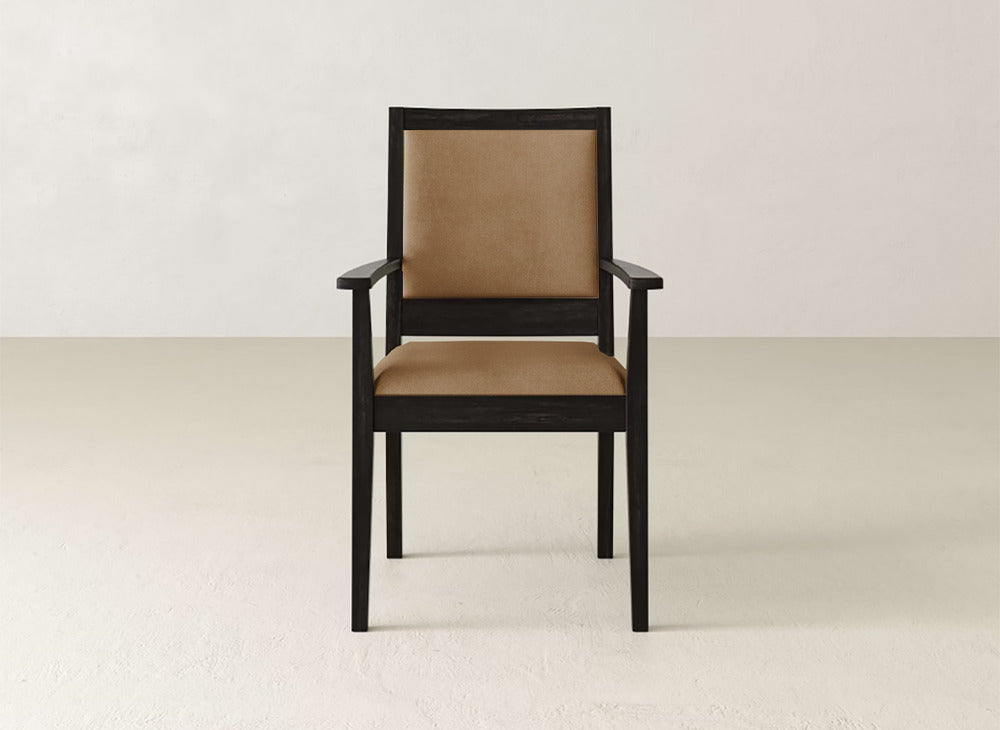 The James+James Gina Arm Dining Chair features a dark maple wood frame with light brown upholstery on the seat and back, making it a stylish contemporary addition to any dining space.