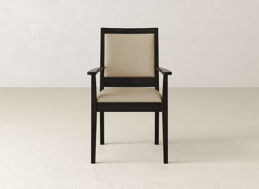 The James+James Gina Arm Dining Chair is a contemporary piece with a dark maple frame and light beige upholstered seat and backrest, shown against a plain light background.
