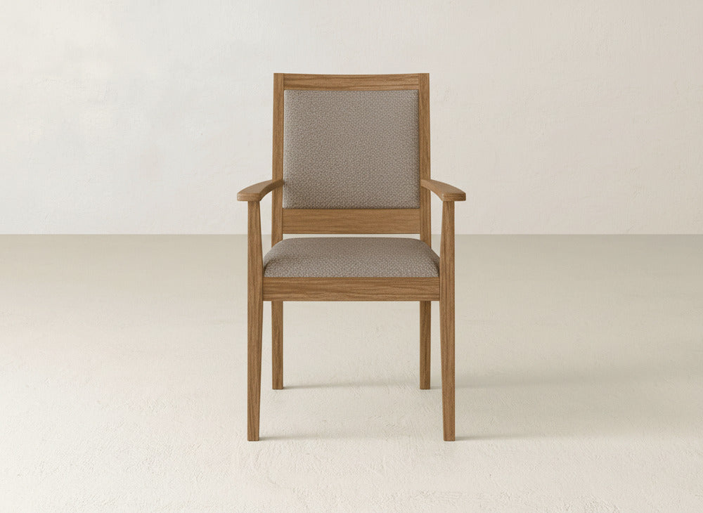 The Gina Arm Dining Chair by James+James is a modern maple wood chair with armrests and a beige upholstered seat and back, shown against a plain, light background.