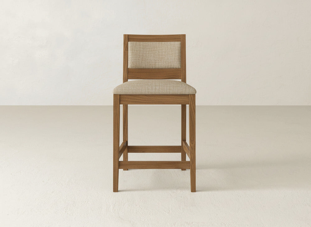 The Gina Side Stool by James & James showcases modern design with a light brown maple wood frame and beige upholstered seat and backrest, set against a plain, light-colored background.