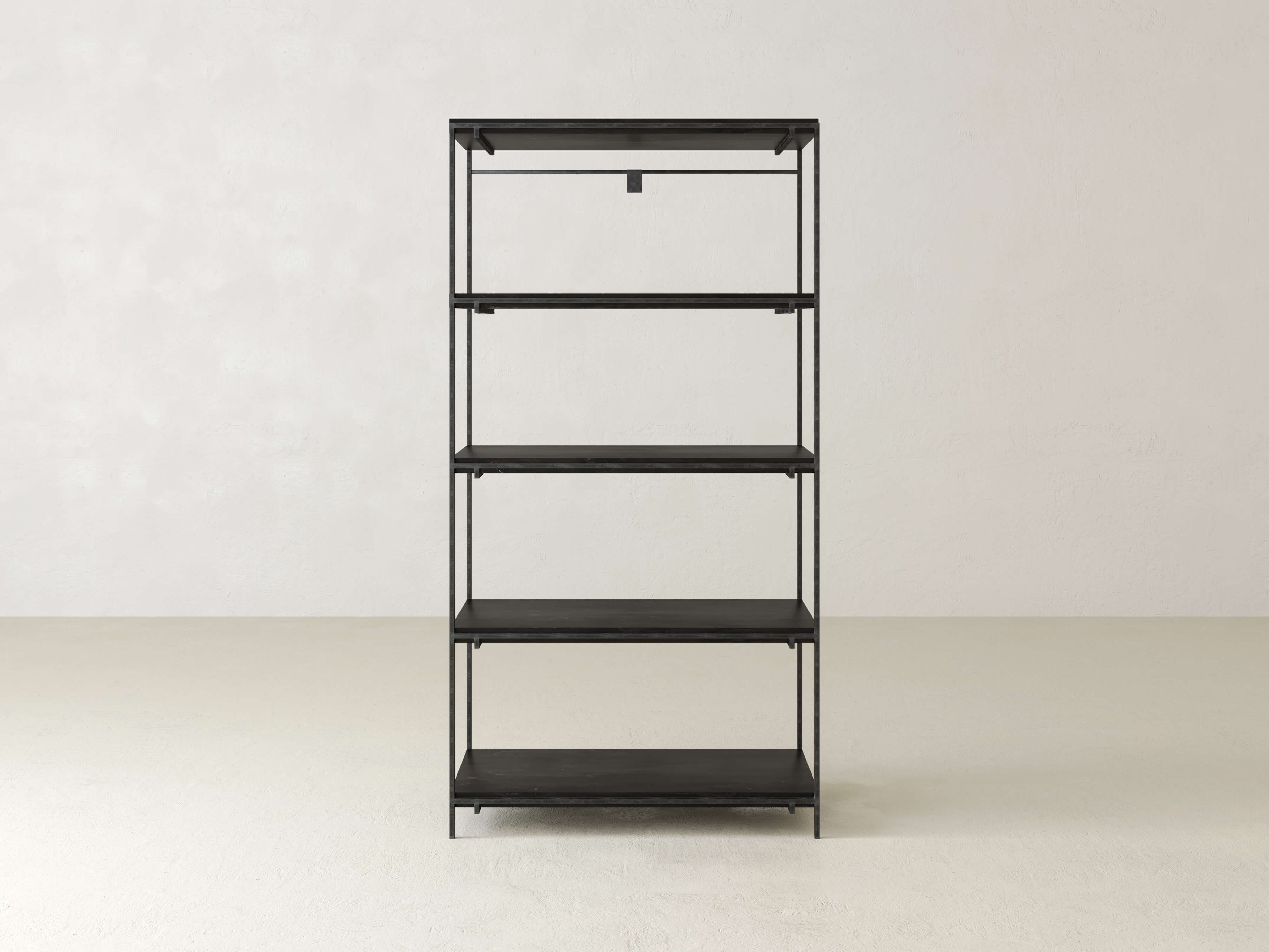 Minimalist black metal shelving unit with five tiers standing against a plain off-white wall and light-colored floor. The shelves are empty, highlighting the clean, sleek design.