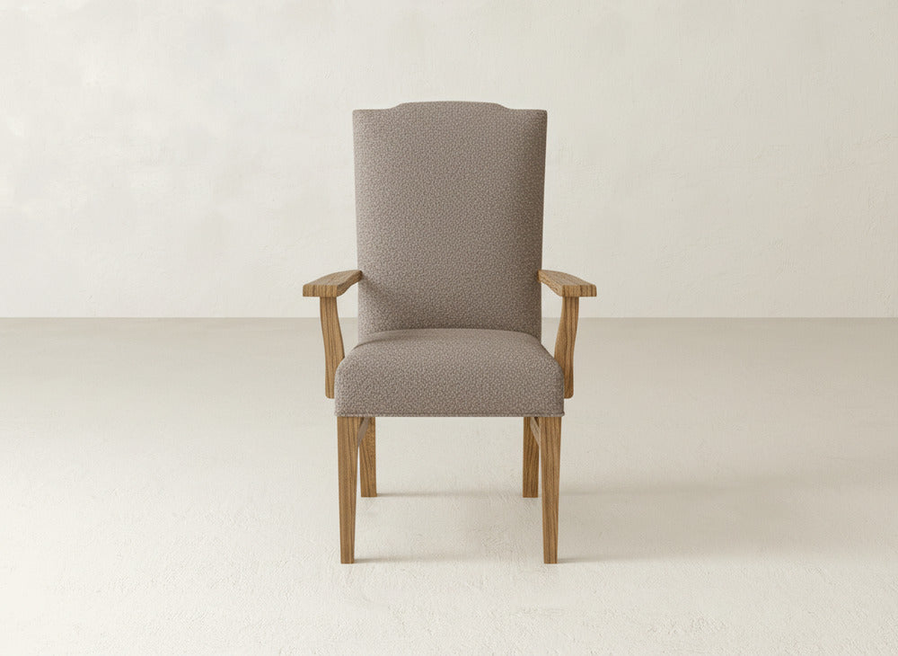 A straight-on view of the James+James Hadley Arm Dining Chair, featuring a modern high back, light wood legs and armrests, and textured light beige upholstery, set against a plain, light-colored background.