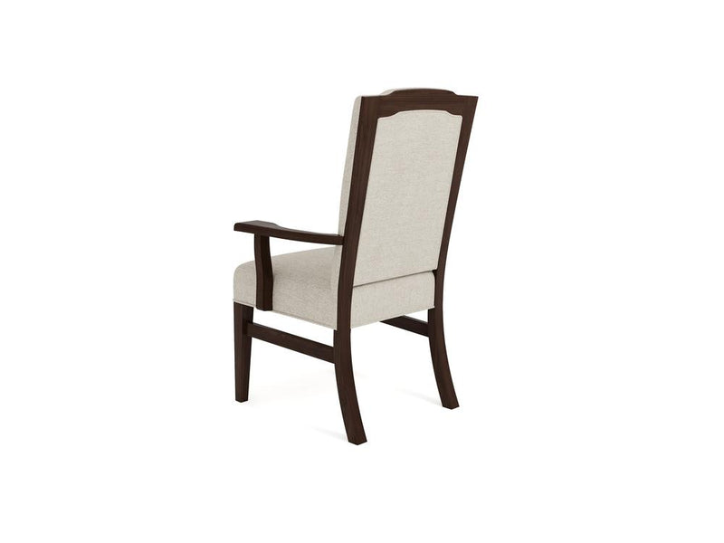 A wooden chair with a dark brown frame and light beige cushioned backrest, seat, and armrests is shown from the back and side angle against a white background. The chair features a traditional design with slightly curved legs.