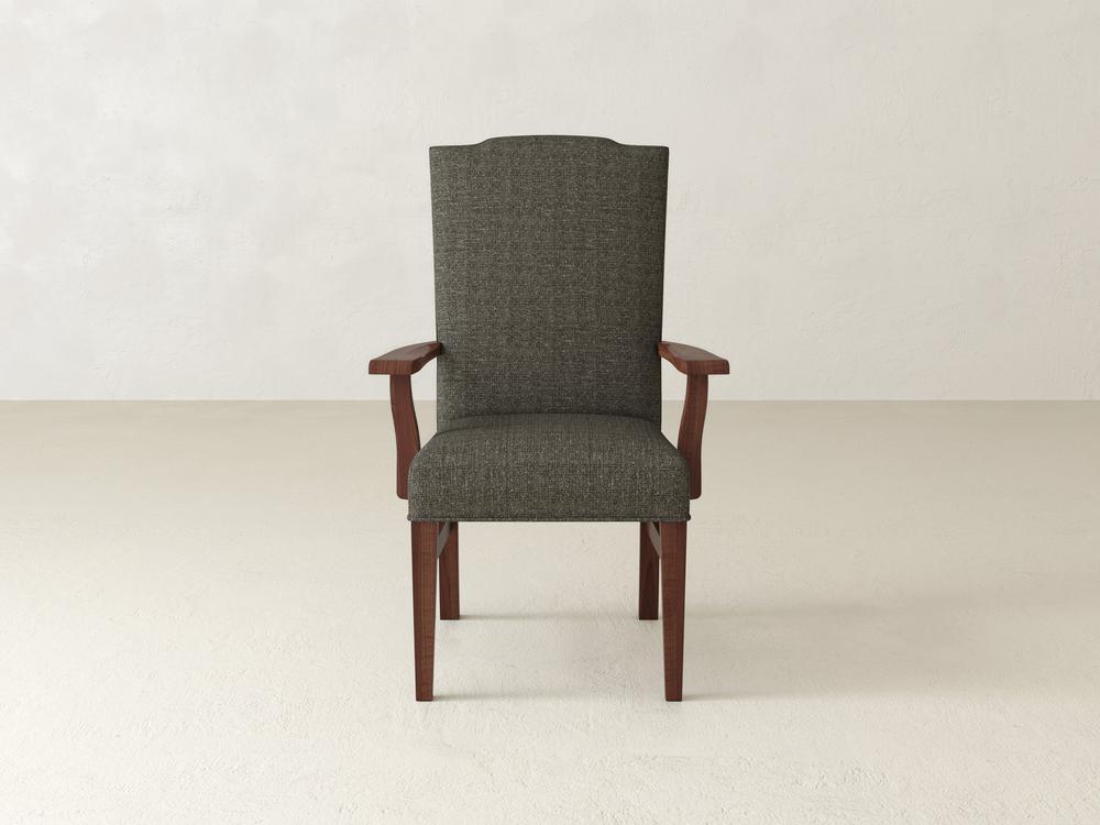 The Hadley Arm Dining Chair - Tuscany by James+James features a green upholstered seat with wooden armrests and legs, set against a plain white backdrop.