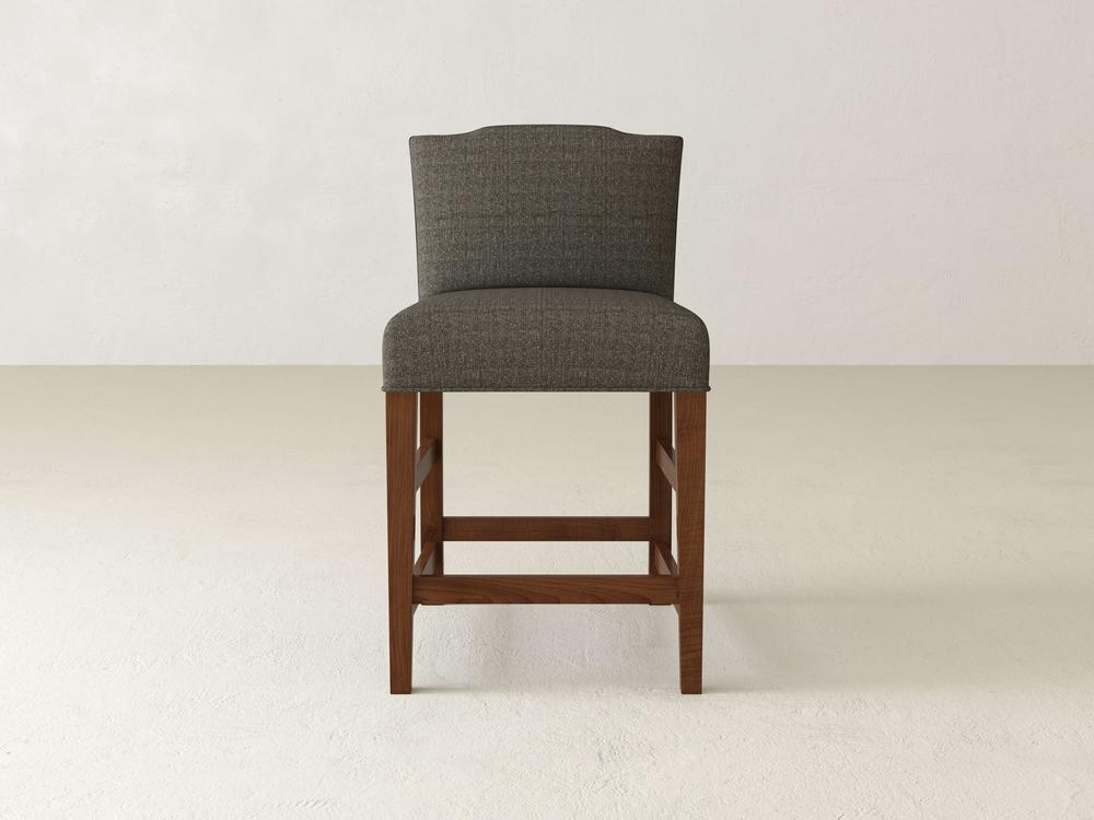 Introducing the Hadley Upholstered Stool by James & James: a stylish, modern bar stool with a gray upholstered seat and high backrest. Its dark wooden frame and legs elevate your dining experience against any light-colored backdrop.