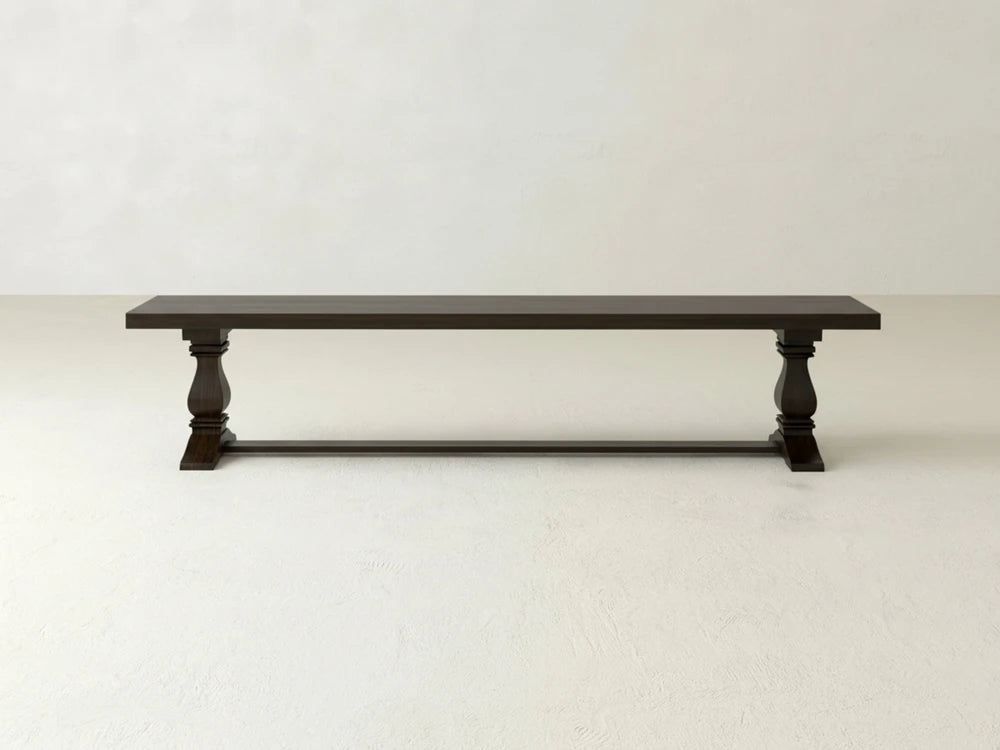The Heirloom Bench by James+James features a rectangular oak seat in an espresso finish and turned legs, shown against a plain light-colored background.