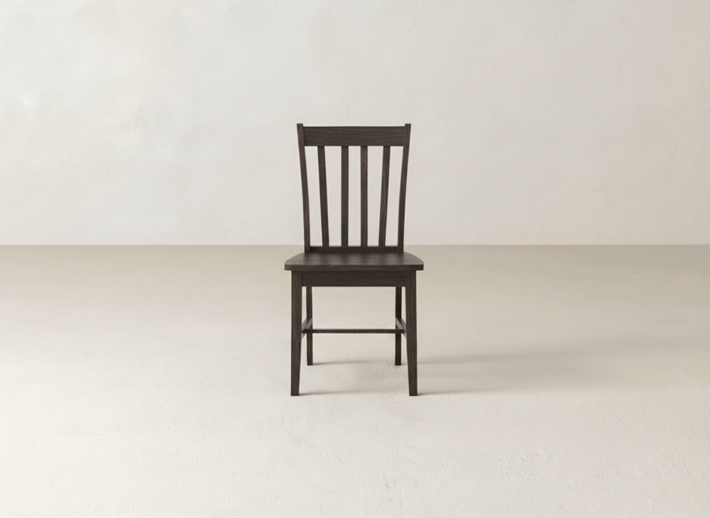 The James+James Henry Dining Chair, with its dark wood and classic slat-back design, is showcased in an empty, light-toned room—ideal for refined dining spaces.