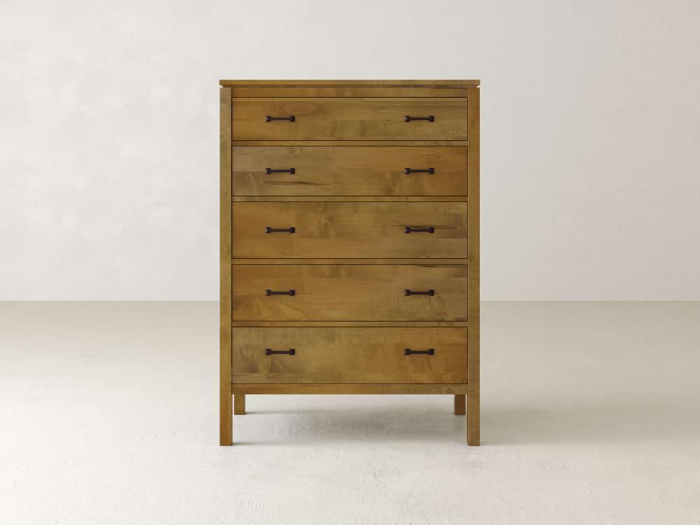 The Jensen Tall Chest from James & James is a modern solid maple hardwood chest with five compartments and dark metal handles. It stands on short legs, blending seamlessly into its plain, light-colored background.
