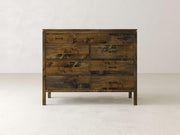 The James & James Jensen 9 Drawer Dresser radiates rustic charm with its maple hardwood build. Its nine drawers, arranged neatly in three rows, feature simple handles and a natural textured finish that complements any modern design against a plain white background.