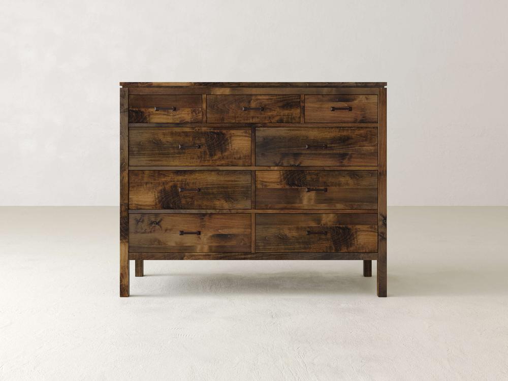Introducing the Jensen 9-Drawer Dresser by James & James, a rustic piece crafted from solid maple hardwood with a natural finish and visible wood grain. This modern design includes nine drawers in varying sizes with simple metal pulls, set against a plain white background.