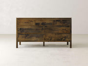 The James & James Jensen 7 Drawer Dresser, made from solid maple hardwood with a rustic finish and dark handles, stands out against light walls and floors. Its natural wood grain enhances any room with a contemporary appearance.