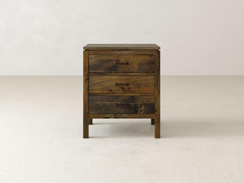 The Jensen 3 Drawer Nightstand by James & James provides convenient bedside storage with its solid maple hardwood construction, rustic natural wood grain finish, and simple rectangular drawer handles against a plain white background.