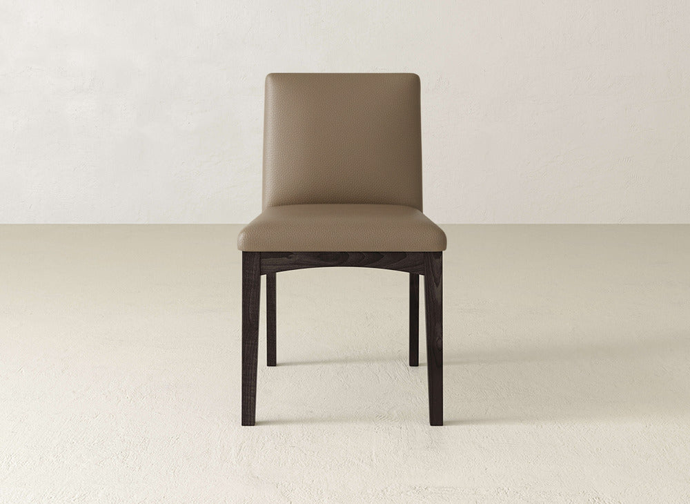The James & James Klein Dining Chair features a light brown cushioned seat and back, dark maple legs, and adds elegance to any space with its refined style.
