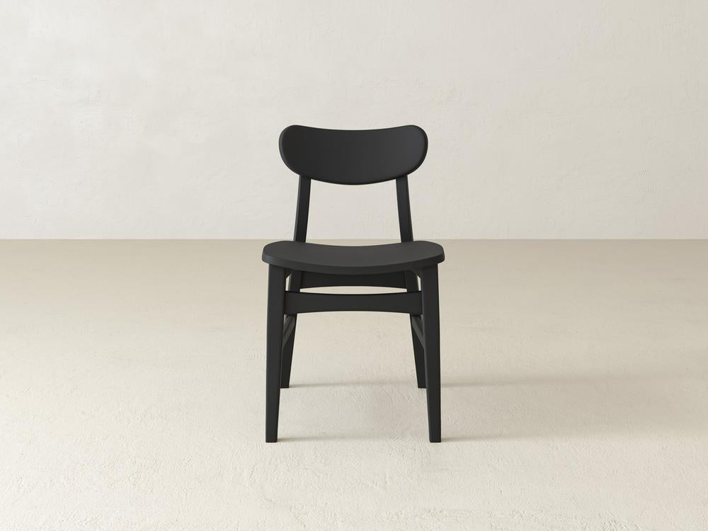 A wooden chair with a curved backrest and seat, featuring simple legs and a minimalist design, set against a plain off-white background.
