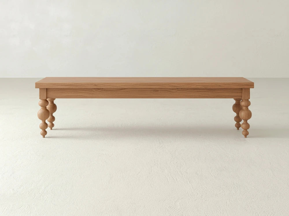 The Olivia Bench - Oak on Oak by James+James features a simple rectangular wooden seat with four turned spindle-style legs, shown against a plain, light-colored background.
