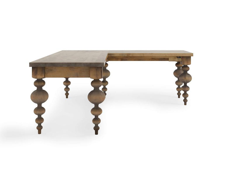 The Olivia Corner Desk - Harvest Wheat by James+James is a rustic, L-shaped wooden desk with a distressed finish, featuring rounded, ornate turned legs. With its weathered vintage appearance, it adds a classic rustic charm to any space. The elongated side extends to the left.