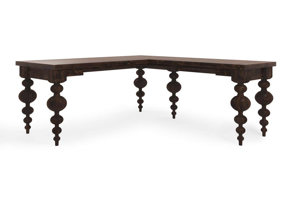 The Olivia Corner Desk - Tobacco by James+James is a dark wood L-shaped desk featuring intricately carved, turned legs with bulbous and tapered shapes that give it a unique, vintage appearance. The flat and spacious surface makes it suitable for an office or home workspace.