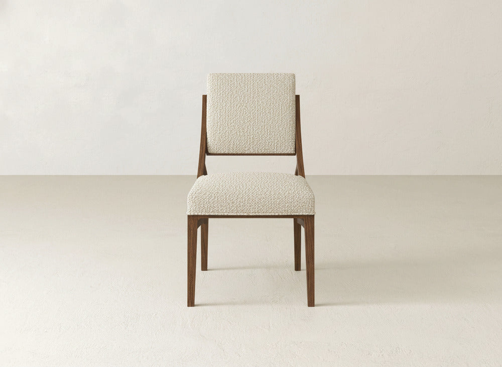 The Quinn Dining Chair by James+James features a modern wood frame and upholstered, textured light seat and backrest—a stylish choice to elevate your dining room décor.