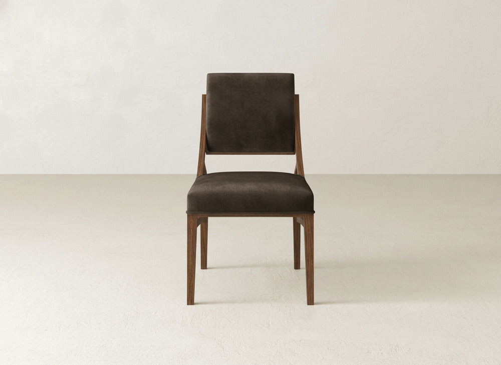 The Quinn Dining Chair by James+James features a wooden frame with a dark brown upholstered seat and backrest—ideal for adding style to your dining space.