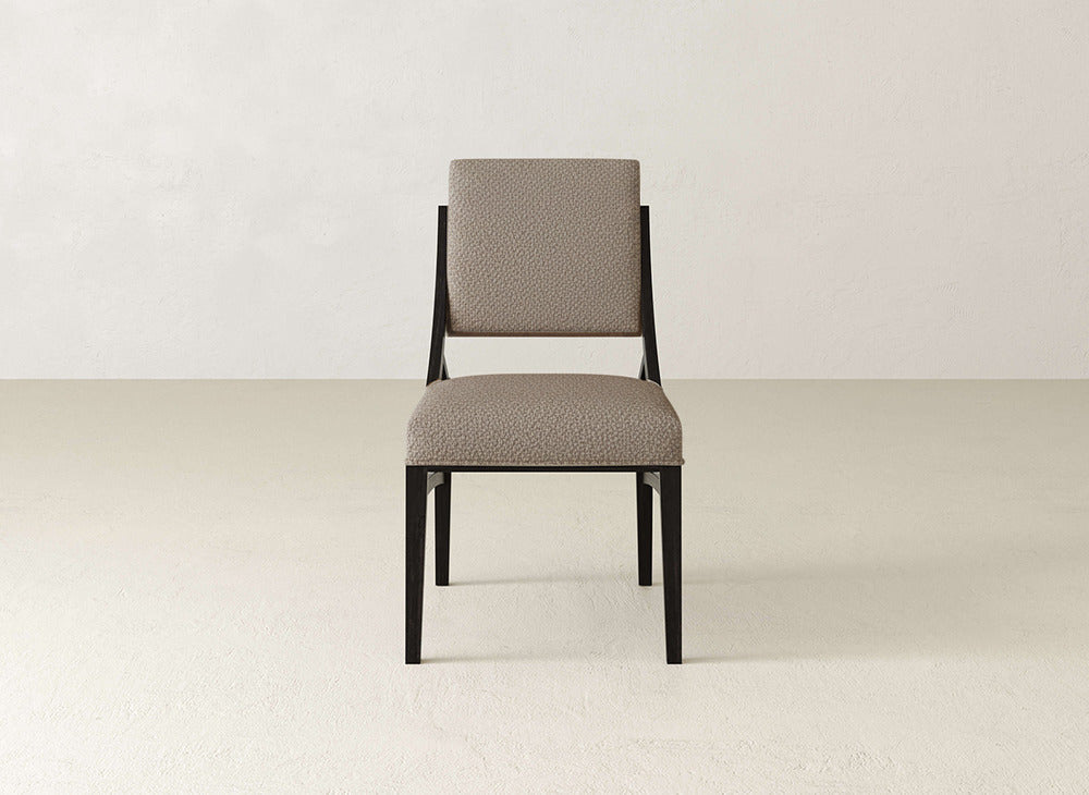 The Quinn Dining Chair by James+James features modern upholstery with a black metal frame and light beige seat and backrest, ideal for enhancing your dining room decor in any neutral space.