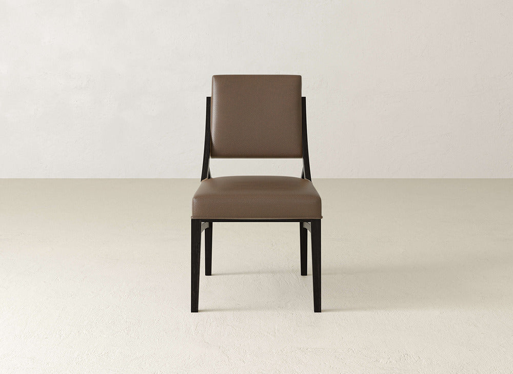 The Quinn Dining Chair by James+James features a modern brown upholstered seat and back, black metal legs, and adds style to your dining room décor.