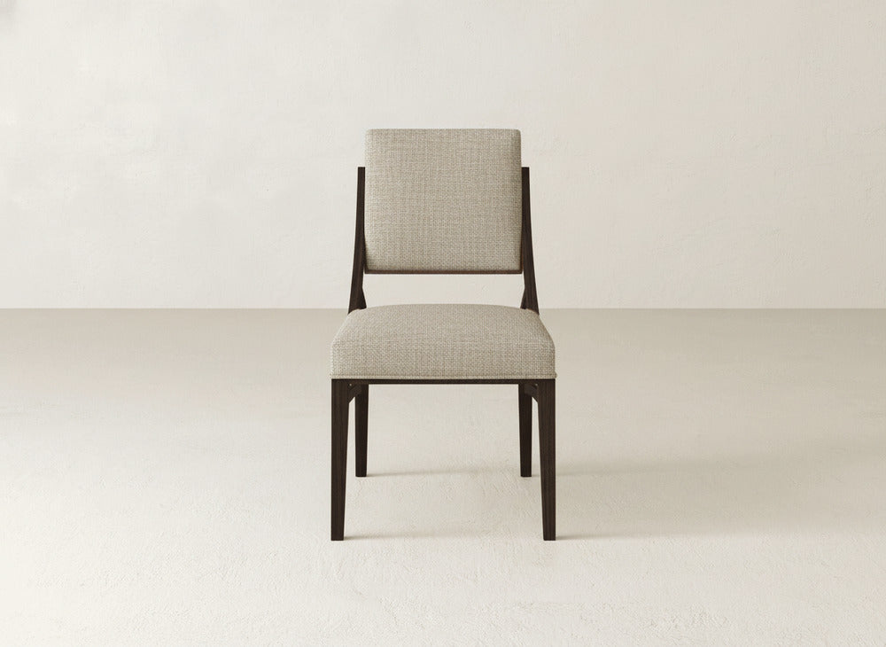 The Quinn Dining Chair by James+James features a dark wooden frame with a light gray upholstered seat and backrest—an elegant, modern choice to enhance any dining room decor.