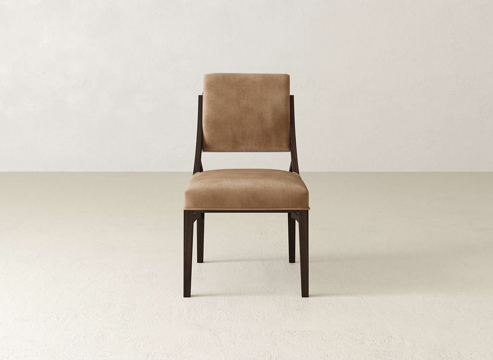 A brown Quinn Dining Chair by James+James with a straight back and dark wood frame sits on a light floor against a neutral wall, bringing refined style to your dining room decor.
