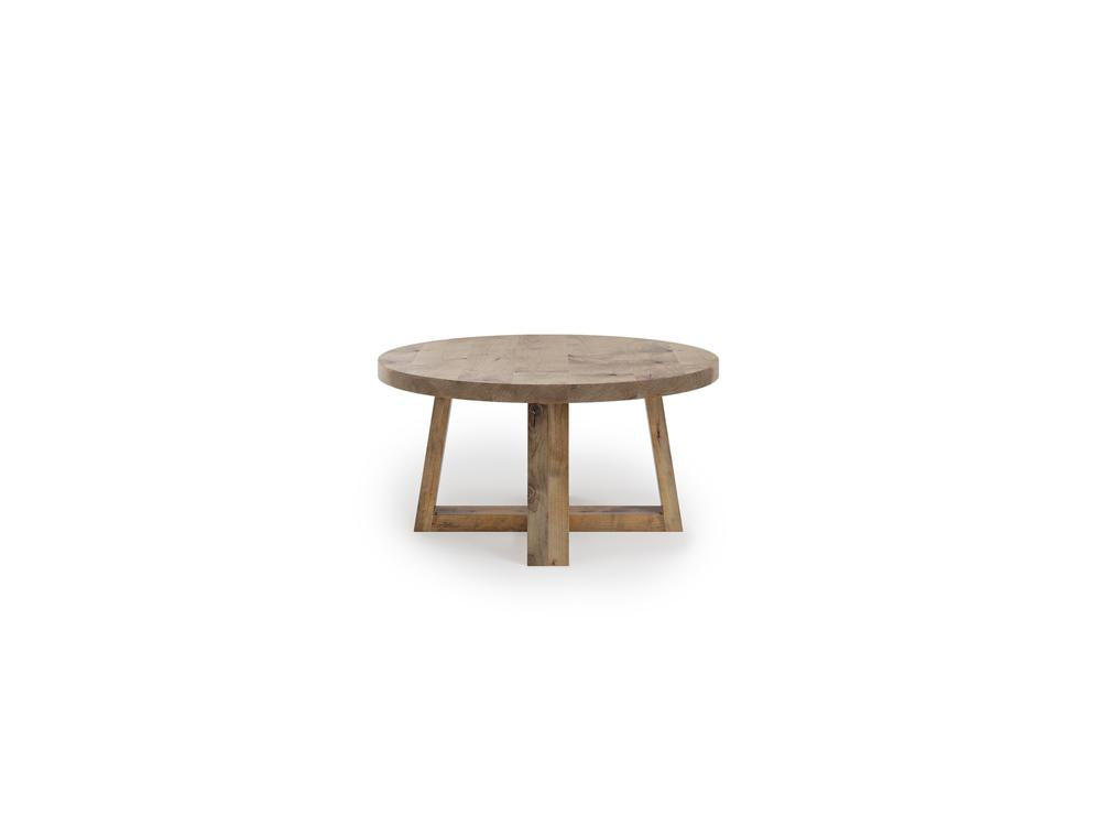 The Rae Coffee Table - Harvest Wheat by James+James boasts a simple, minimalist design with a round, natural wood finish tabletop. The base features four angled legs that intersect at the center for added stability, elegantly placed on a white background.