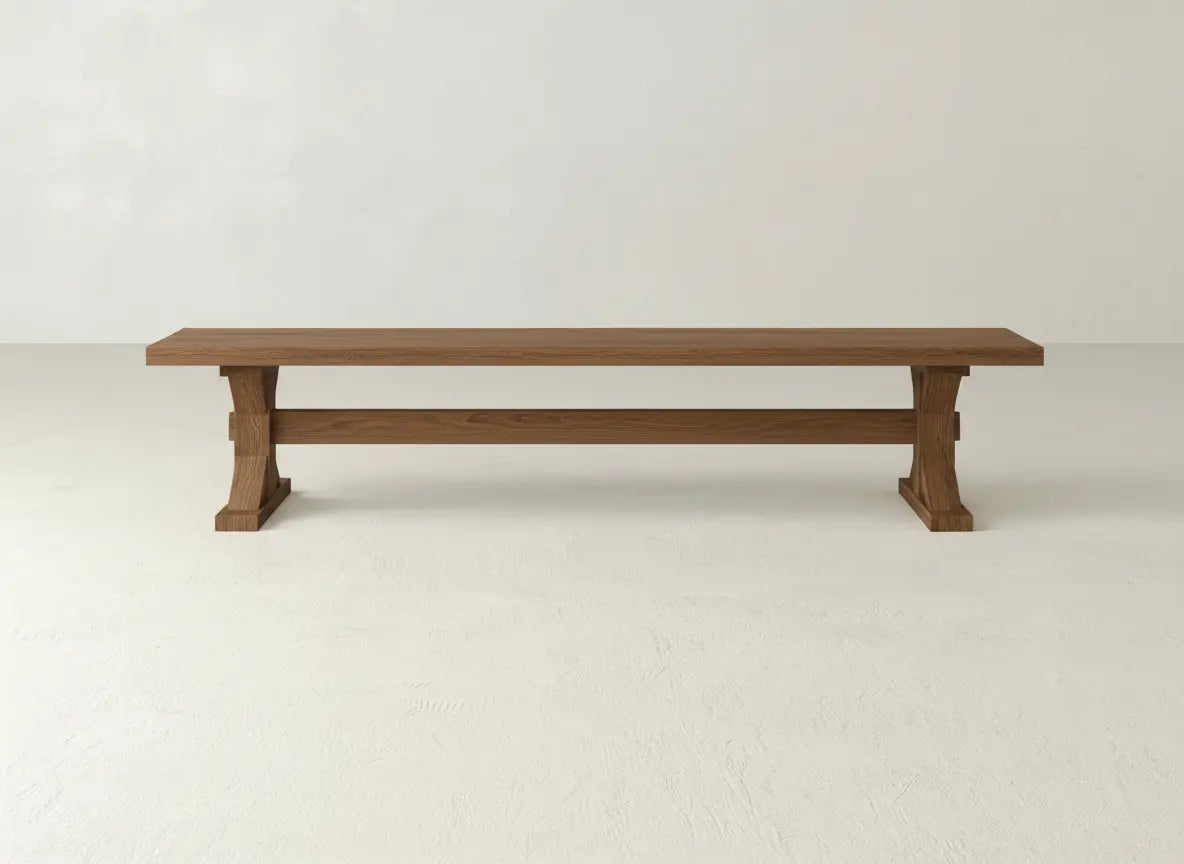 The James+James Trestle Bench - Almond on Oak features a long, rectangular design with a simple, sturdy build, shown against a plain white background.
