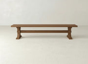 The James+James Trestle Bench - Almond on Oak features a long, rectangular design with a simple, sturdy build, shown against a plain white background.