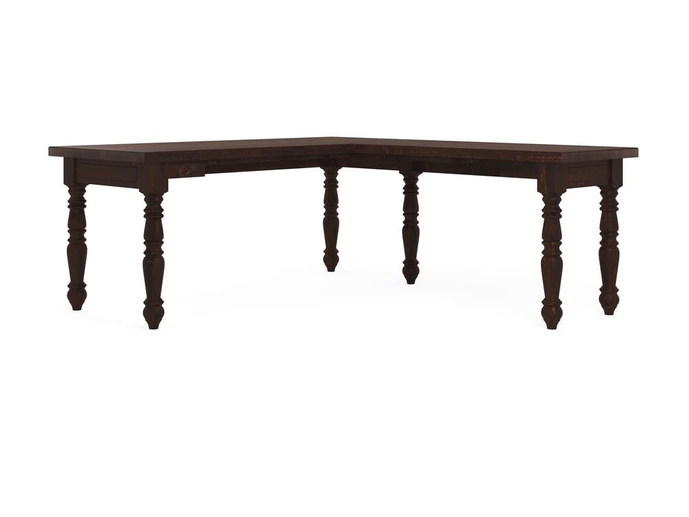 The Turned Leg Corner Desk - Tobacco by James+James is an L-shaped wooden table with intricately carved legs. It features a dark finish and classic style, showcasing detailed craftsmanship.