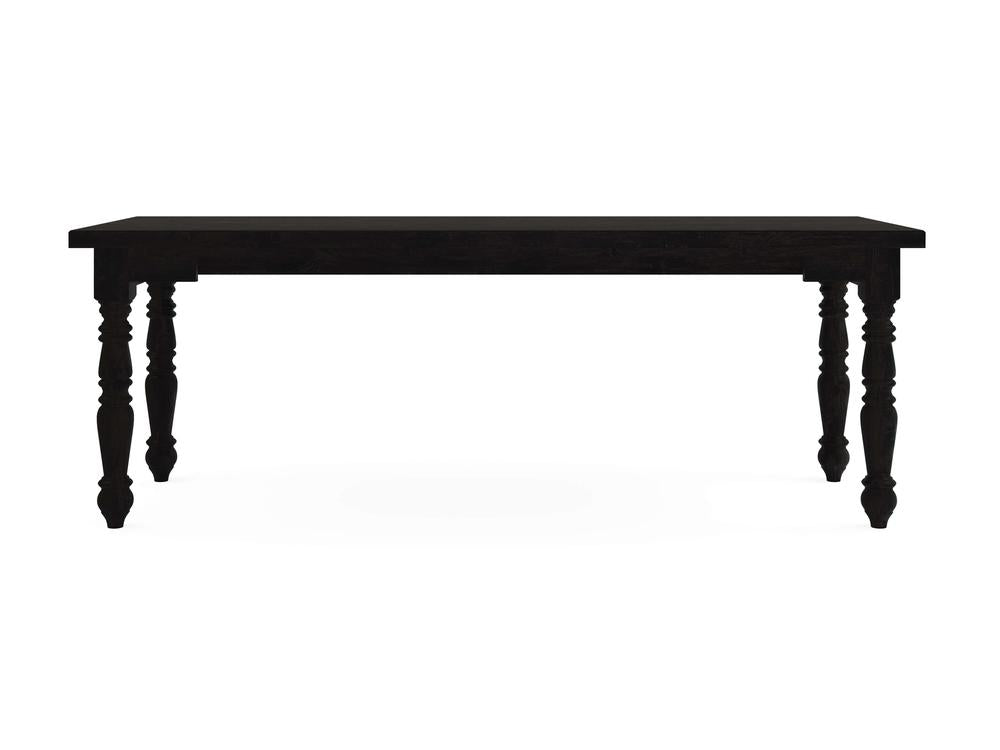 The Turned Leg Desk - Charred Ember by James+James features a rectangular top with intricately carved legs, set against a plain white background.