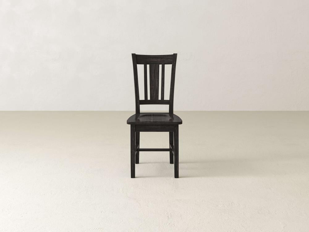 The William Dining Chair - Tobacco by James+James is a wooden chair with a dark brown finish, viewed from an angle showing its back and right side. The chair features a simple design with a slatted backrest, square seat, and straight legs reinforced with horizontal supports.